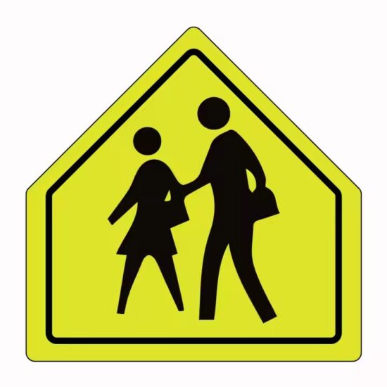 Reflective School Zone Warning Sign Installed by Roadside